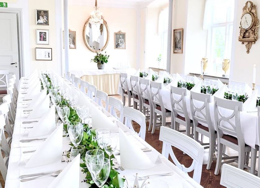 Drottning Victorias Hotell & Vilohem in Borgholm dining room set with long white banquet tables and chairs