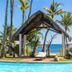 Voi Amarina Resort in Nosy Be with a tropical poolside, palm trees and ocean view