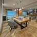 City Express Plus by Marriott Tijuana lounge with shared work table, laptops, and seating