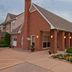 Residence Inn by Marriott Davenport exterior entrance with brick facade and landscaped flower beds