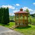 Red Roof Inn Hillsville in Hillsville: gazebo beside manicured lawn, tall evergreens, and parking lot
