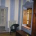 Agriturismo Podere Pratovecchio room with striped walls, mirror, chair, radiator and open window in Montefollonico