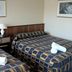 Midtown Motor Inn Whanganui room with two double beds and bedside lamp