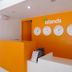 Islands Stay Hotels - Puerto Princesa reception desk with orange wall and island clocks