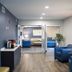 Stayapt Suites College Station lobby with blue seating, coffee station, and glass doors in Bryan