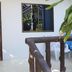 Aonang Sr Bungalow in Ao Nang with a wooden room door, balcony railing, and patio seating