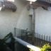 Las Iglesias Antigua courtyard terrace with table, chairs, and red loungers beside stucco walls