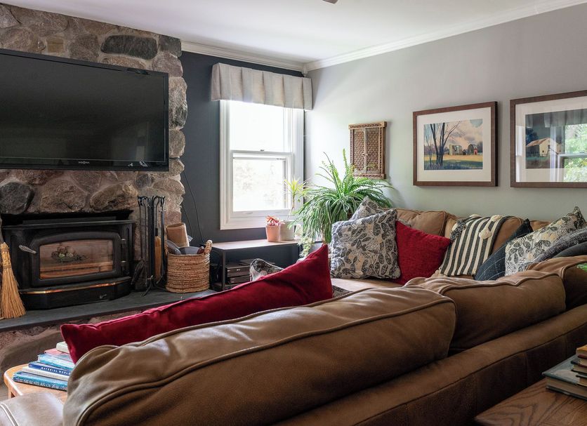 Glenn Meadow Bed and Breakfast in South Haven living room with stone fireplace, TV and cozy sectional