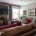 Glenn Meadow Bed and Breakfast in South Haven living room with stone fireplace, TV and cozy sectional