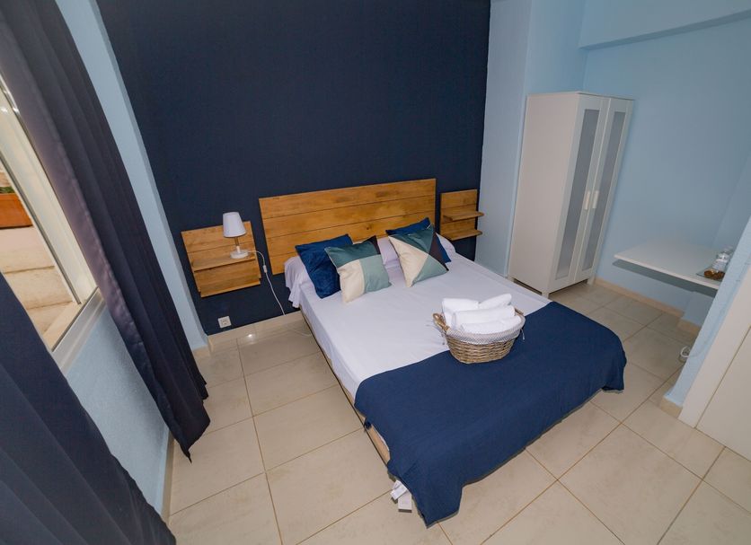 Old Town Alicante guest room with double bed, navy bedding, and compact wardrobe in Alicante