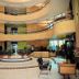 Hotel Devi Grand, Katra: spacious multi-level hotel lobby with curved balconies and central seating area