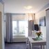 Hotel Altes Kurhaus room in Ostseebad Baabe with twin beds, window, TV and small table