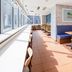Comfort Hotel Narita in Narita lounge with blue banquette seating, yellow chairs, and floor-to-ceiling windows