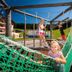 Children playing on a rope hammock at Gasthaus-Landhotel Traunstein, Abtenau, with mountain views.