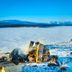 Arctic Gourmet Cabin in Kiruna with a snowy lakeside fire pit and mountain view