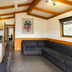 Nrma Ballarat Holiday Park in Ballarat: cabin interior with kitchen, dining table, and sectional sofa