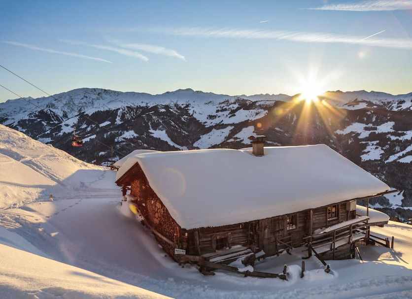 Hotel Elisabeth in Kirchberg in Tirol: snow-covered alpine cabin with mountain sunrise view