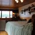 Kiwassa Lake Bed & Breakfast room in Saranac Lake with lake view, wood ceiling, and bed