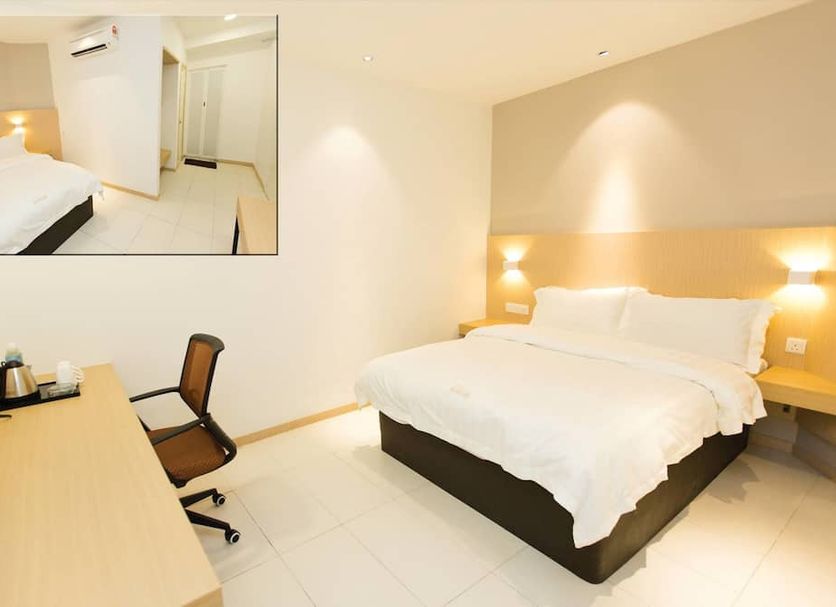 Extreme Boutique Hotel Kluang guest room with double bed, desk, chair, and inset room preview