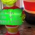 Inflatable holiday character holding a green "I'm Here for the Presents" sign at The Macaw Guesthouse, New York