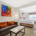 Best Western Plus Rose City Conference Center Inn suite with sofa, coffee table, and king bed in Thomasville