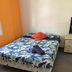 Abel's Central Backpackers in Nelson, simple guest room with double bed and bedside drawers