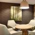 Fairfield Inn & Suites by Marriott Sierra Vista lounge with round table, white chairs and stone accent wall