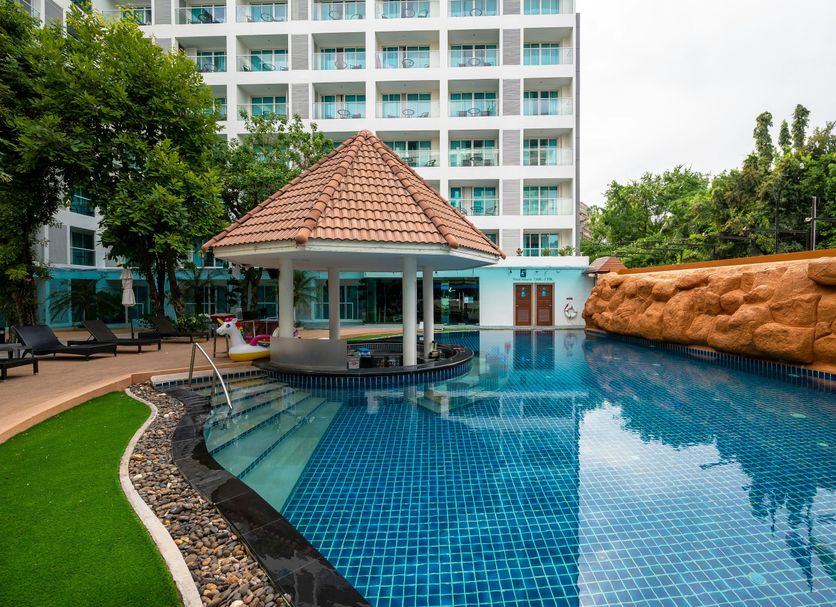 Centara Pattaya Hotel pool with gazebo, lounge chairs and resort tower in Pattaya