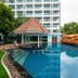 Centara Pattaya Hotel pool with gazebo, lounge chairs and resort tower in Pattaya
