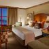 Faraway Jackson Hole guest room with king bed, mountain view window, and cozy seating in Teton Village