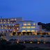 Kythea Resort in Agia Pelagia lit up at dusk on a hillside above the sea