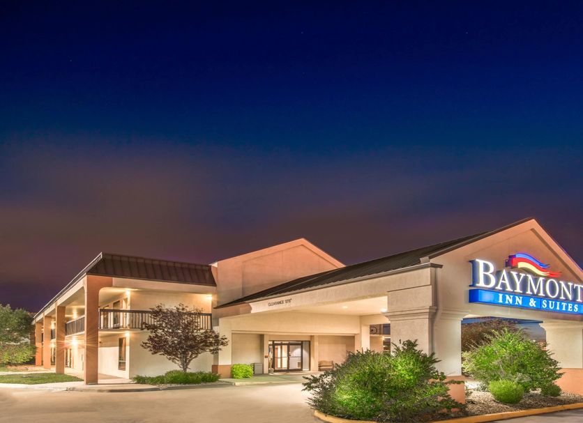 Baymont by Wyndham Topeka exterior at dusk with illuminated entrance and sign