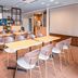 Comfort Hotel Narita meeting room with tables, chairs, and a small coffee station in Narita