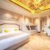 Grand Metropark Guofeng Hotel Tangshan guest room with bunk bed, king bed and ornate chandelier