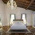 The Stay Galata in Istanbul bedroom with chandelier, wood ceiling, tiled floor, and glass shower