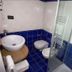 Affittacamere Da Cesare bathroom in Monterosso al Mare with blue tile, sink, toilet and glass shower