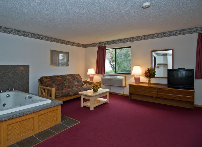 America's Best Value Inn & Suites International Falls room with jacuzzi tub, sofa, coffee table, TV and window