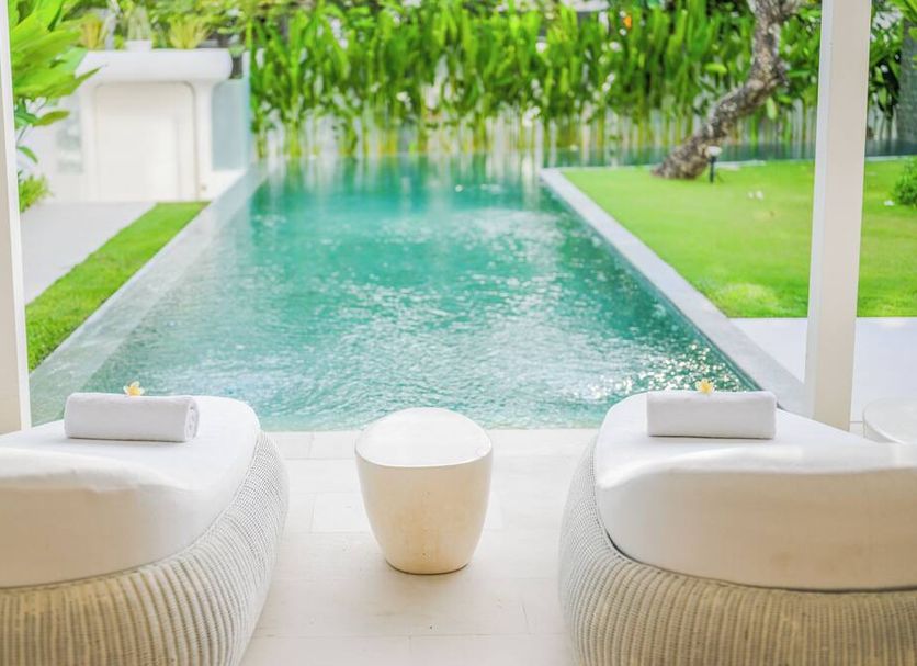 Eden The Residence at The Sea Seminyak in North Kuta, poolside loungers overlooking a tropical pool