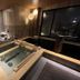 Onyado Nono Asakusa Bettei in Tokyo features a serene indoor hot spring bath with wood accents