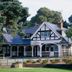 The Lodge At Meyrick Park in Bournemouth, a black-and-white lodge-style hotel surrounded by trees