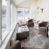 Hawksmoor Guest House in Windermere sunroom with seating and large windows