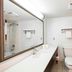Red Roof Inn & Suites Stafford, VA - Quantico bathroom with vanity, toilet, tub and red-striped shower curtain