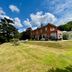 The Upper House in Stoke-on-Trent, red-brick hotel on a grassy hillside under a blue sky