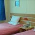 Home Inn Guiyang West Gate guest room with two twin beds and a window with blue curtains in Guiyang