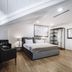 Hotel Citadel Narikala room in Tbilisi with bed, armchair, and sloped ceiling