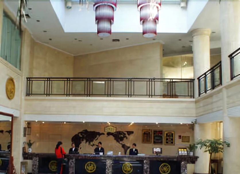 Orange Crystal Hotel Xuzhou Suning Plaza lobby with front desk, mezzanine balcony and skylight in Xuzhou