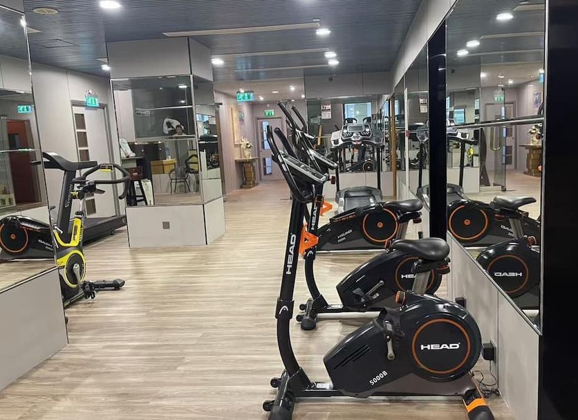 Metropark Hotel Macau gym with stationary bikes and mirrors in Macau