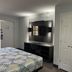 Studio 6 Huntsville, AL University Drive room with bed, wall-mounted TV and closet in Huntsville