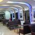 Balkan Palace Edirne lobby seating area with tufted sofas, glass tables, and arched ceiling lights
