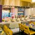 TIME Grand Plaza Hotel in Dubai dining area with buffet counters and yellow upholstered chairs